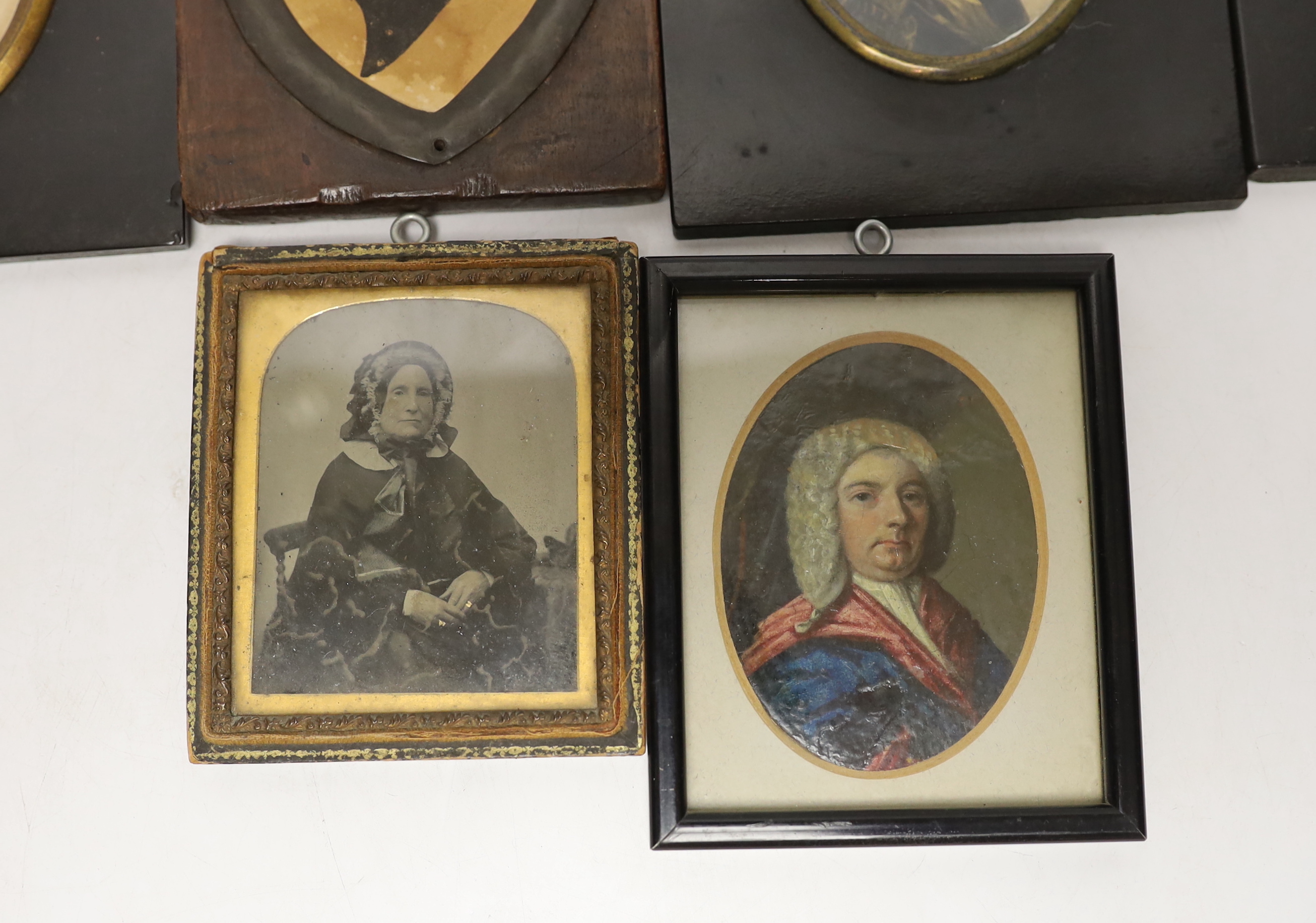 A quantity of miniatures comprising oil of an 18th century gentleman wearing a wig, three 19th century silhouettes, Victorian blue and white photograph and one other